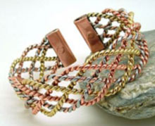 A wider design of three colour lace measuring 20mm wide, made from light twists of copper and brass woven in a lace design with enough aluminum to give a three colour look. Each tab-end is fitted with a rare earth magnet