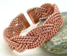 A Celtic plait design made from twists of copper plaited together to form a 20mm wide heavy copper bracelet. Each tab-end is fitted with a rare earth magnet